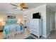 Cozy bedroom with comfortable bed, dresser, ceiling fan, and easy access to Primary bath at 805 N Bay Blvd, Anna Maria, FL 34216