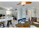 Coastal dining area featuring seating for six, ceiling fan, breakfast bar, and beachy decor at 805 N Bay Blvd, Anna Maria, FL 34216