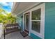 Porch featuring seating, door with window, and blue siding on a sunny day at 805 N Bay Blvd, Anna Maria, FL 34216