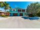 Charming two-story beach home with a screened-in porch, two-car garage, and lush tropical landscaping at 805 N Bay Blvd, Anna Maria, FL 34216