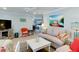 Comfortable living room with beachy accents, couches, TV, and open kitchen view at 805 N Bay Blvd, Anna Maria, FL 34216