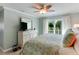 Comfortable primary bedroom with white dresser, ceiling fan, and balcony doors with natural light at 805 N Bay Blvd, Anna Maria, FL 34216