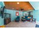 An outdoor living space offers comfortable seating, a TV, and easy access to the pool area for entertaining at 805 N Bay Blvd, Anna Maria, FL 34216