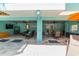 Enjoy Florida living with a covered outdoor entertainment area, seating, dining, and a television at 805 N Bay Blvd, Anna Maria, FL 34216