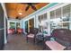 Comfortable screened-in porch features ceiling fans and wicker furniture for relaxing and enjoying the coastal breeze at 805 N Bay Blvd, Anna Maria, FL 34216