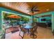 Spacious backyard offers a covered patio with a dining area, a seating area, and a clear view of the pool at 805 N Bay Blvd, Anna Maria, FL 34216