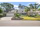 Charming single-story home with a well-manicured lawn, mature landscaping, and a two-car garage at 811 Hammockwood Ct, Sarasota, FL 34232