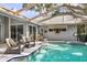 Relax in this beautiful pool featuring a spa, comfortable seating, and a covered enclosure, perfect for outdoor entertaining at 811 Hammockwood Ct, Sarasota, FL 34232