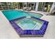Inviting pool and spa with blue tile accents, offering a refreshing outdoor oasis for relaxation and entertainment at 811 Hammockwood Ct, Sarasota, FL 34232