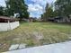 Large grassy backyard featuring a shed and fenced perimeter at 831 Bacon Ave, Sarasota, FL 34232