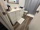 Bathroom featuring a white vanity with modern fixtures, and a shower with a gray curtain at 831 Bacon Ave, Sarasota, FL 34232