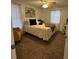 Comfortable bedroom featuring a cozy bed with patterned bedding, a yellow chair, and natural light at 831 Bacon Ave, Sarasota, FL 34232