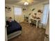 Bedroom featuring neutral walls, a bed with blue bedding, and a white desk area with natural light at 831 Bacon Ave, Sarasota, FL 34232
