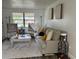 Inviting living room with neutral tones, comfortable seating, and natural light from the window at 831 Bacon Ave, Sarasota, FL 34232