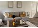 Cozy living room featuring a comfortable gray sofa, decorative pillows, and modern artwork on the wall at 831 Bacon Ave, Sarasota, FL 34232