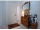 Welcoming entryway with tiled floor, decorative wooden dresser, and front door at 9641 Castle Point Dr # 1211, Sarasota, FL 34238