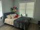 Bedroom with soft bedding and a large window creating a cozy and inviting atmosphere at 1002 E Ida St, Tampa, FL 33603