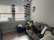 A bedroom furnished with a gray couch and black bin full of items, illuminated by natural light at 1002 E Ida St, Tampa, FL 33603