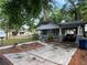 View of the front exterior of a quaint house with a covered carport and landscaped yard at 1002 E Ida St, Tampa, FL 33603