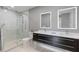 Modern bathroom with glass shower, dual vanities, and contemporary fixtures at 1064 N Tamiami Trl # 1604, Sarasota, FL 34236