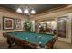 Billiard room with a well-maintained pool table, elegant lighting, and comfortable seating for entertainment at 1064 N Tamiami Trl # 1604, Sarasota, FL 34236