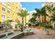 Beautiful courtyard with lush greenery, a water fountain, and inviting architectural details at 1064 N Tamiami Trl # 1604, Sarasota, FL 34236