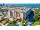Beautiful condominium with a view of the water, pool, and palm trees at 1064 N Tamiami Trl # 1604, Sarasota, FL 34236