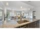 Open concept living area featuring granite counter tops and view into living and dining areas at 1064 N Tamiami Trl # 1604, Sarasota, FL 34236