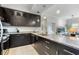 Open kitchen boasts granite countertops, stainless appliances, and sleek black cabinets at 1064 N Tamiami Trl # 1604, Sarasota, FL 34236