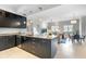 Modern kitchen with black cabinets, granite countertops, and stainless steel appliances at 1064 N Tamiami Trl # 1604, Sarasota, FL 34236