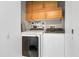 The laundry room has a washer, dryer, and storage cabinets at 1064 N Tamiami Trl # 1604, Sarasota, FL 34236
