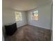 Inviting bedroom with wood floors, and dual windows creating a bright, airy space at 107 Grove Rd, Venice, FL 34293
