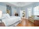 Relax in this bedroom featuring wood floors, with a king bed and access to an attached sitting area at 108 Amora Ave, Venice, FL 34285