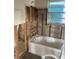Bathroom under renovation, the walls are open with exposed studs, old bathtub, and outdated decor at 109 Colonia W Ln, Nokomis, FL 34275