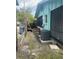 Exterior side view of house, showcasing the yard with AC unit at 109 Colonia W Ln, Nokomis, FL 34275