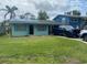 Charming one-story home featuring a spacious front yard, cheerful color scheme, and ample parking at 109 Colonia W Ln, Nokomis, FL 34275