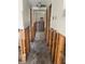 Hallway under renovation, walls are open with exposed studs, and the flooring is unfinished at 109 Colonia W Ln, Nokomis, FL 34275