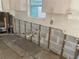Kitchen in need of renovation, with old cabinets, exposed wall structure, and open plumbing at 109 Colonia W Ln, Nokomis, FL 34275
