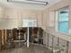 Kitchen in need of renovation, exposed wall structure, old cabinets, with microwave at 109 Colonia W Ln, Nokomis, FL 34275