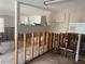 Kitchen is undergoing renovations, walls are open with exposed studs, a large space, with old cabinets at 109 Colonia W Ln, Nokomis, FL 34275