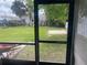 Looking out from a screened patio to a lush yard and tropical landscaping at 109 Colonia W Ln, Nokomis, FL 34275