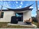 Back patio with a modern sunshade sail, a grill, Adirondack chairs, and a fire pit at 1107 22Nd E St, Palmetto, FL 34221