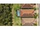 Aerial view showcases the backyard pool of this home and lush green space of the surrounding lots at 11499 Renaissance Blvd, Venice, FL 34293