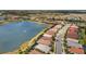 Stunning aerial view of homes along the lake showcasing lush landscaping and serene waterfront living at 11499 Renaissance Blvd, Venice, FL 34293