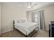 Cozy bedroom with neutral walls, wood-look flooring, and a ceiling fan at 11499 Renaissance Blvd, Venice, FL 34293
