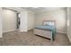 Neutral bedroom with wood-look tile floor, and ceiling fan, next to the doorway leading to another room at 11499 Renaissance Blvd, Venice, FL 34293