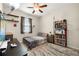 Comfortable bedroom with wood-look floors, shelving and natural light at 11499 Renaissance Blvd, Venice, FL 34293