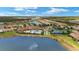 Breathtaking aerial view of the community pool, tennis courts, and beautiful landscaping by the lake at 11499 Renaissance Blvd, Venice, FL 34293