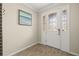 Inviting entryway featuring decorative glass door, tile flooring, and elegant trim at 11499 Renaissance Blvd, Venice, FL 34293