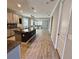 Open kitchen featuring granite countertops and island with a view to the living room at 11499 Renaissance Blvd, Venice, FL 34293
